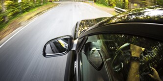 car driving down road
