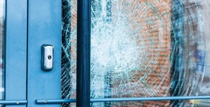 broken glass door with a hole in it