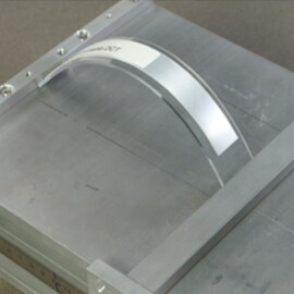 Bent panel anti-lifting test example for electronics bonding curved and foldable surfaces.