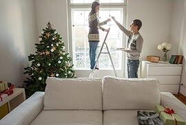  couple decorating their home for the holidays