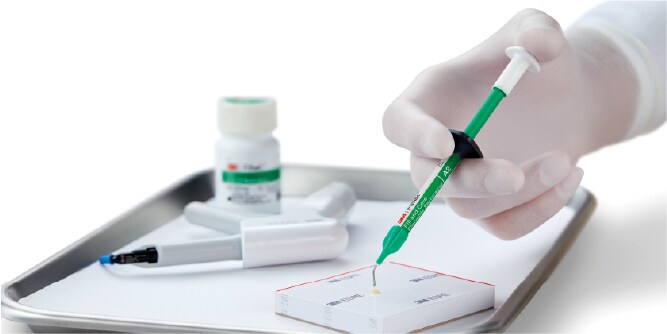 close up of hand picking up syringe
