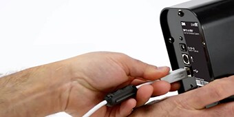 A hand holding a cable
