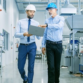Engineers walking through automated manufacturing facility
