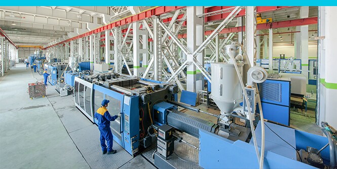 man in facility showing injection molding process
