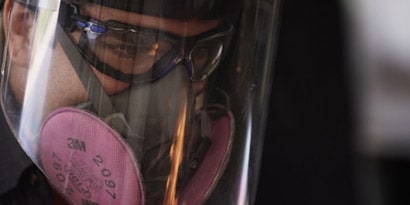tech wearing 3M dusk mask and safety goggles
