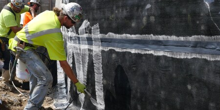 A person painting a wall
