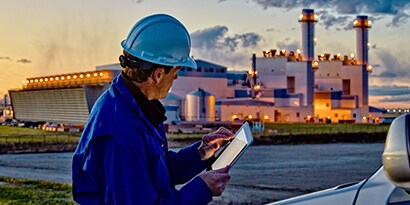 Image of an engineer at a job site, using a tablet.
