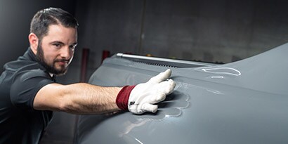 Installer applying film to car