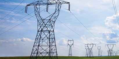 A group of power lines in a field
