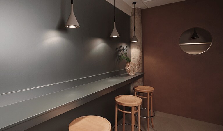 bar with stools and lights

