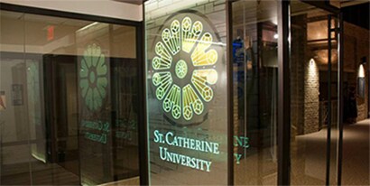 A clear glass window with a flower graphic and the St. Catherine University logo using 3M window graphics.
