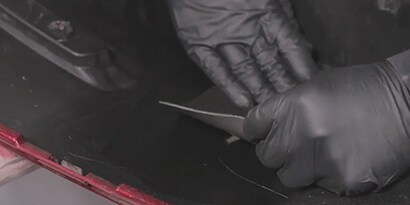 flexible patch being secured to back of bumper
