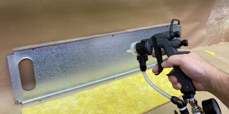 A person spraying a spray object

