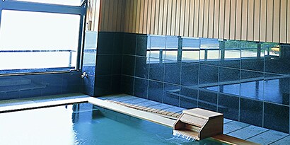 indoor swimming pool with anti-slip mats around pool deck
