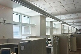 window film on corporate building to reduce glare and redirect sunlight at employess desks