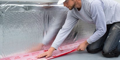 Person applying firestopping product to wall
