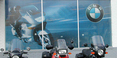 Wall graphic of a motorcycle moving with a big BMW logo in the top right corner, made with 3M wall graphic film.
