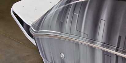 A close up of the side of a boat wrapped in a great and black faded 3M IJ180mC-120 print wrap film.
