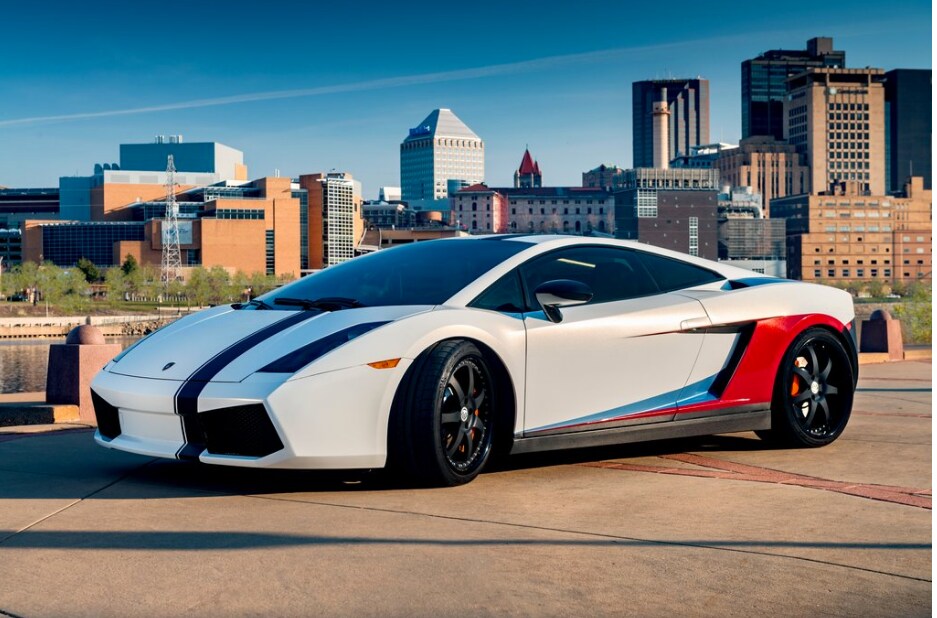 white sports car with a city in the background
