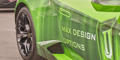 A close up of a green sports car's passenger side door wrapped in 3M IJ180mC-114 print wrap film.
