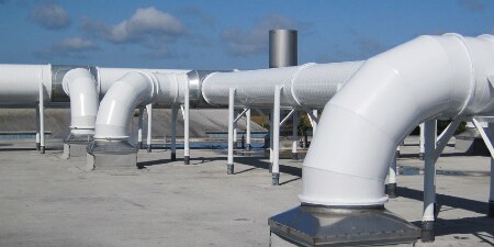 A large white pipes on a concrete surface
