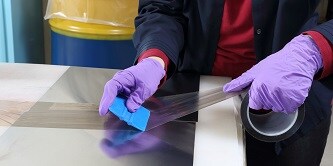 Production worker applies Polytetrafluoroethylene (PTFE) tape to a part
