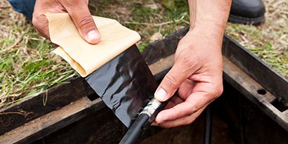 A person using a black plastic wrap
