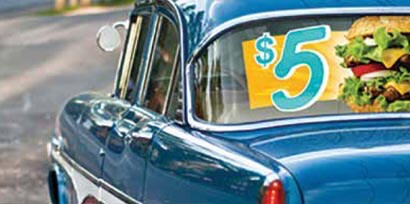 Side of a blue classic car with a big $5 sandwich advertisement put on the back window of the car using 3M IJ67 window graphic film.

