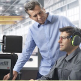 Two workers in front of computer using 3M E-A-Rfit Dual-Ear Validation System