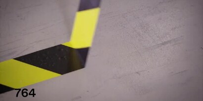 Video still of 3M™ General Purpose Vinyl Tape 764 yellow-and-black stripe tape being pulled up cleanly
