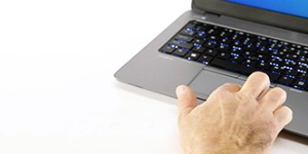 A hand on a computer
