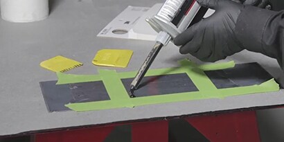technician making sound deadening patch
