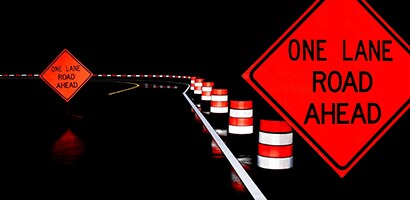road with traffic cones on the side
