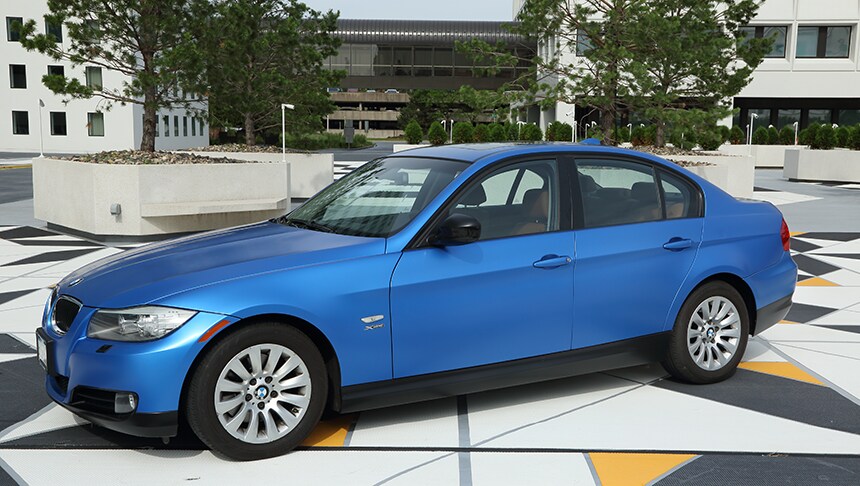 blue car parked on a road
