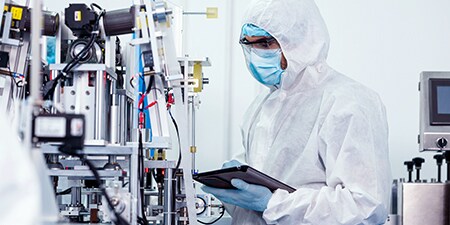 Male engineer checking bioprocessing equipment
