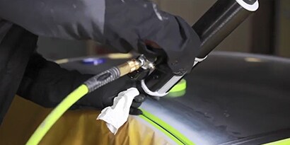 applying seam sealer to a roof channel seam
