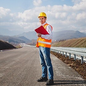 person in a hard hat holding a clipboard