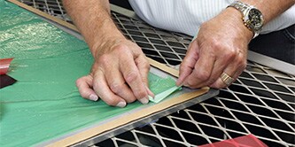 A man is  applying green colored composite bonding 
