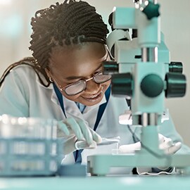 Female scientist looking through a microscope