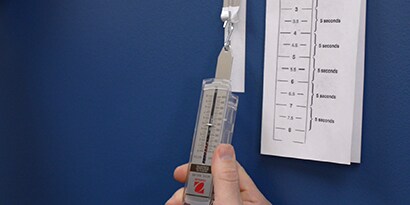 Person holding a 3M film adhesion test instrument
