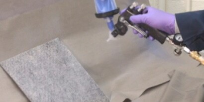 A person using a machine to paint a carpet
