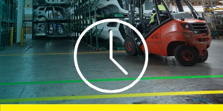 Image of a parked pallet jack with orange tape marking an arc at a social distance
